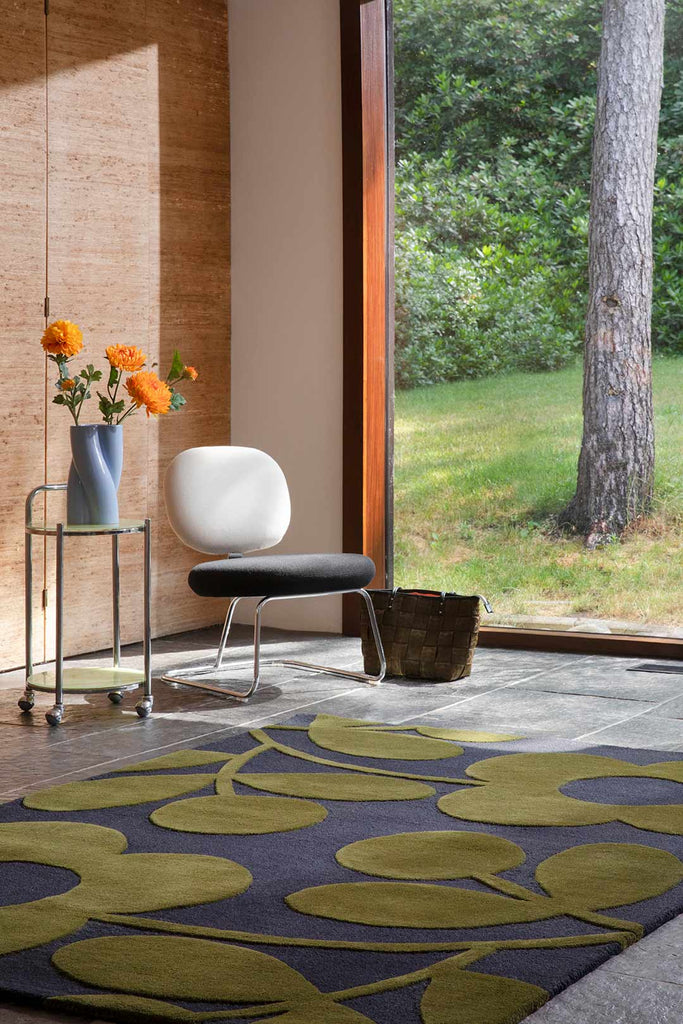 The Orla Kiely Sprig Stem floor rug in colour 'Marine' seen in a stylish retro inspired home