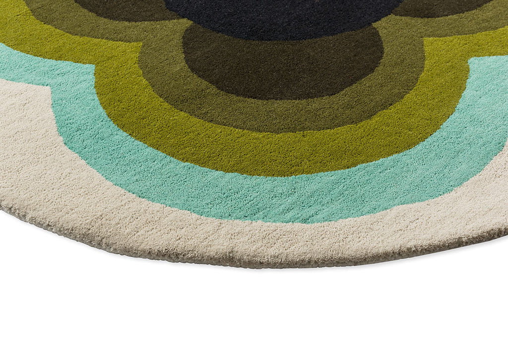 The Orla Kiely round Sunflower rug in olive green tones, seen close up