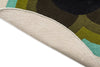 The Orla Kiely round Sunflower rug in olive green tones, seen with edge folded to reveal underneath