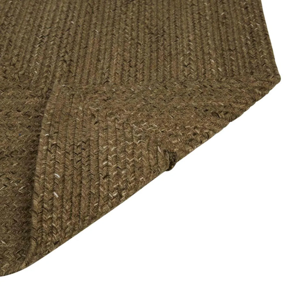 Close up of the weave of the Harbour Braided Outdoor rug with corner folded to reveal underneath