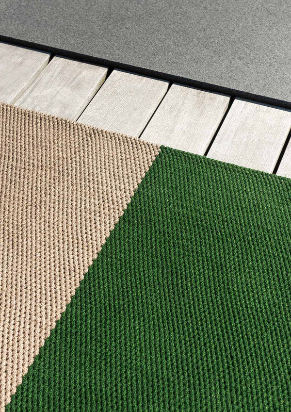 Close up of the stylish green and beige striped designer outdoor rug by Brink and Campman