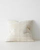A textural cushion with an oversize check pattern in shades of cream and off-white. 