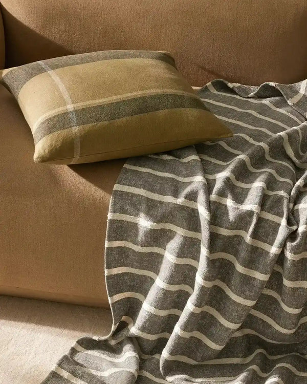 Piazza blue-grey striped throw blanket draped on a couch
