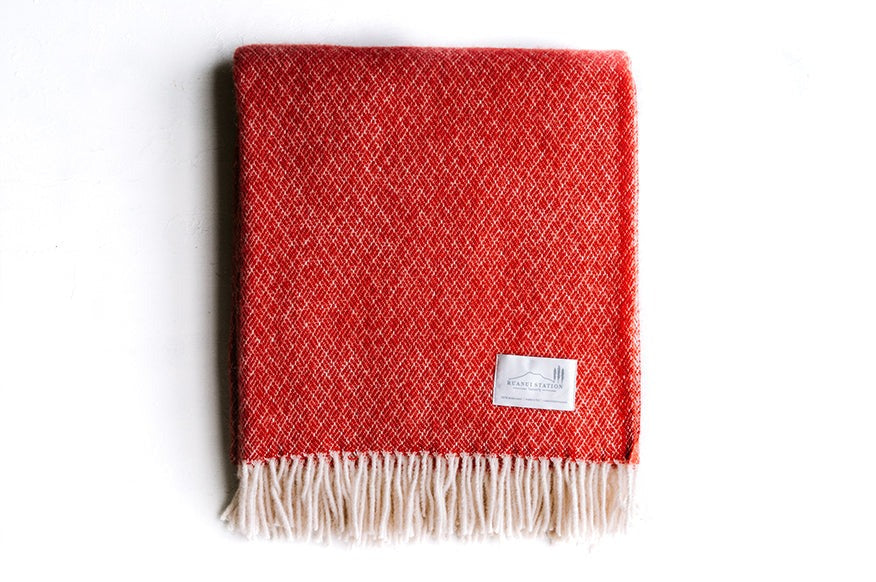100% wool NZ throw blanket by Ruanui Station, in vibrant 'Rakaia red', shown folded