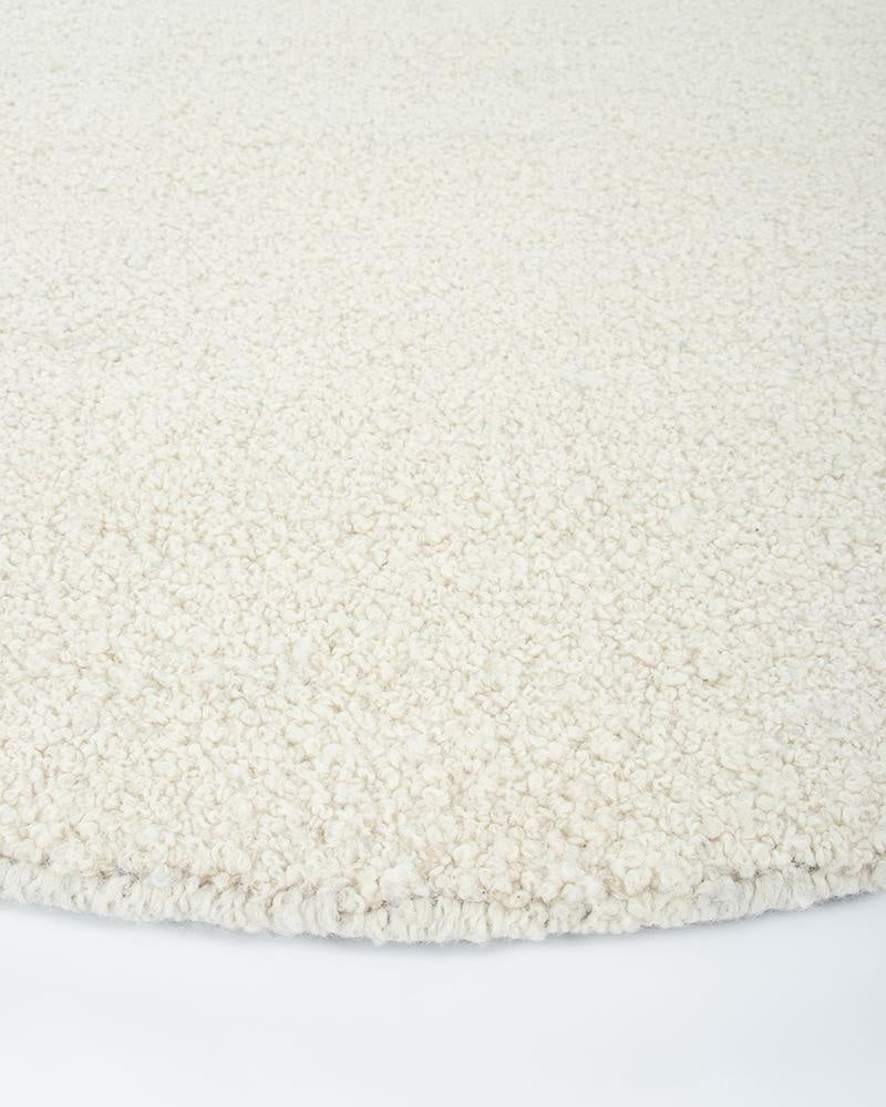 The beautiful Dorset Natural White boucle-style floor rug by Baya, seen close up in perspective