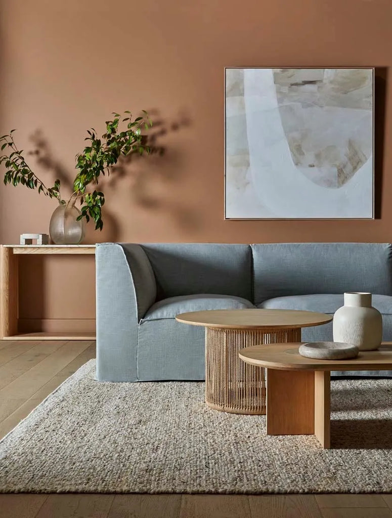  A textural woolen rug, in shades of honey brown and light beige, with subtle colour shifts by Soren Liv NZ and Globe West, situated in a stylish living room.
