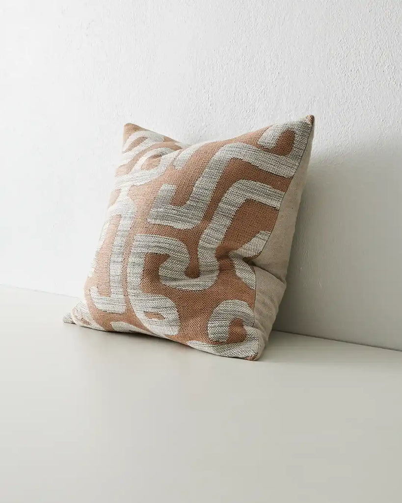 Weave Home Serence Earth designer cushion in an Ikat weave in earthy brown clay tones, seen from the side