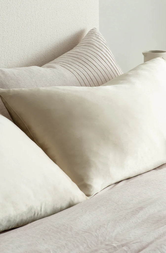 Beautiful silk pillowcase in champagne colour, shown close up on a bed, by Bianca Lorenne