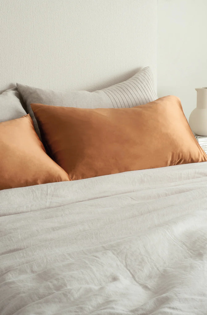 Beautiful silk pillowcases on a bed, colour clay brown, by Bianca Lorenne