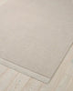 The Silvio wool floor rug in a neutral creamy ecru colour, seen from above