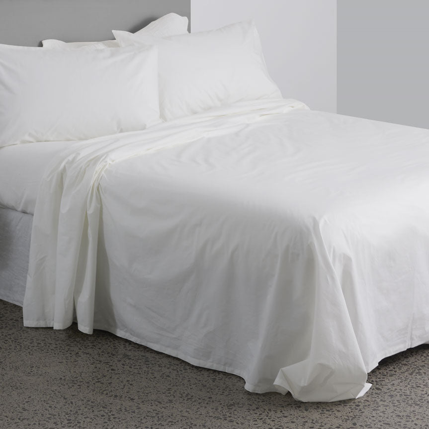 High quality 300 thread count 100% cotton white bed sheets seen on a bed