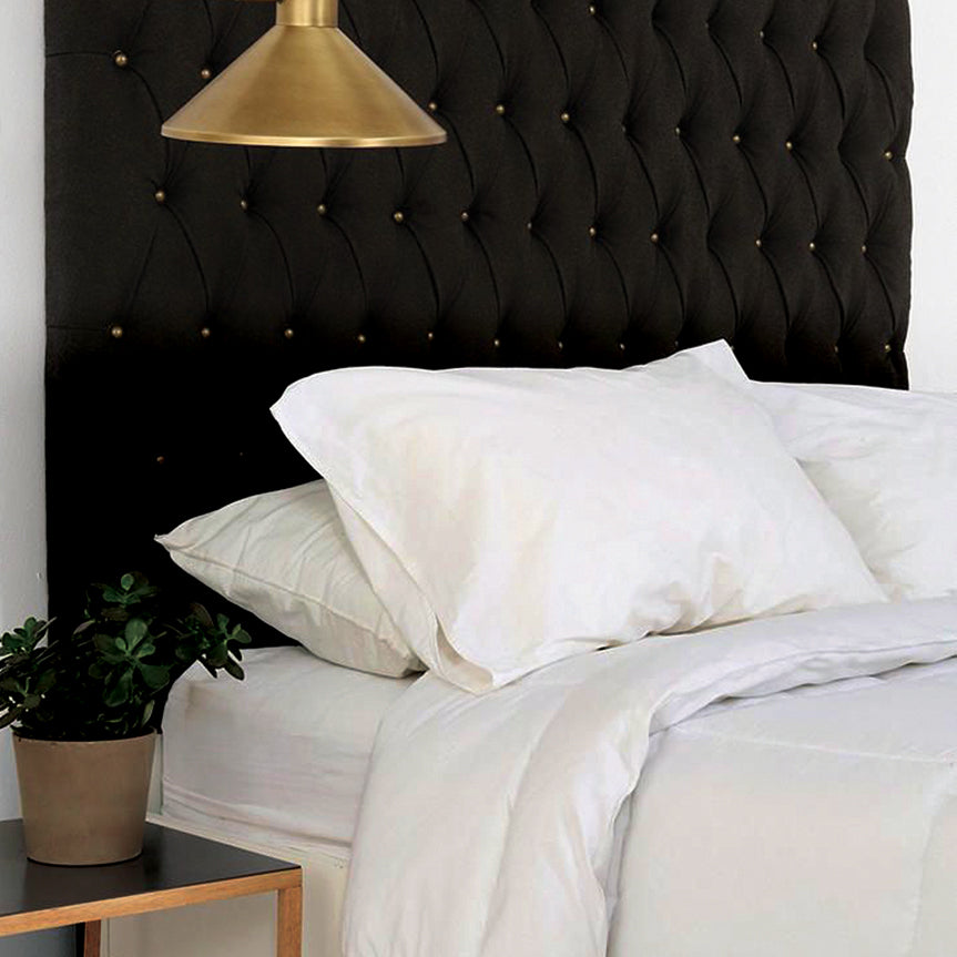 High quality white 100% cotton bed sheets and pillowcases in a stylish room