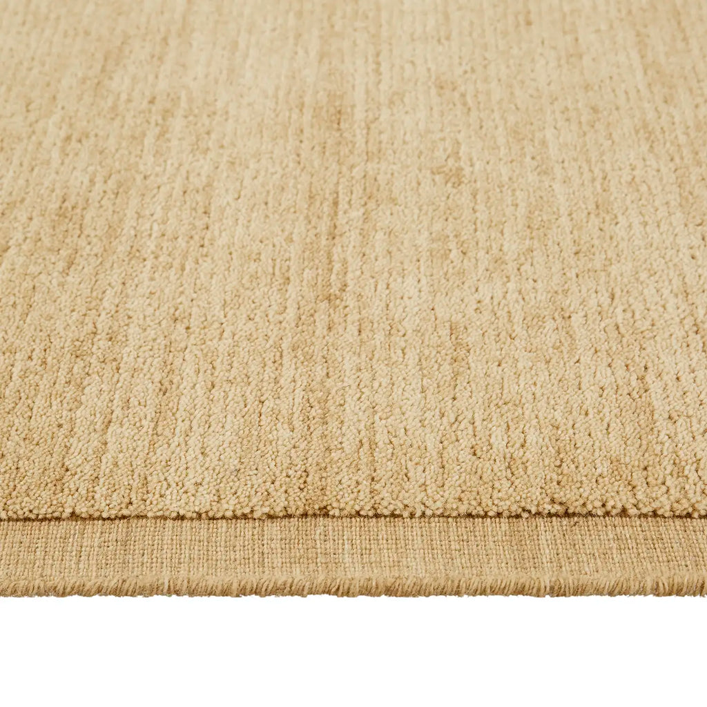 100% wool rug in a soft caramel colour with a contrast frame detail