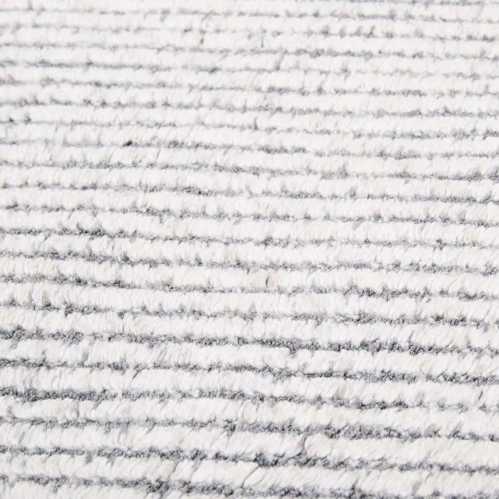 Close up of the weave of a charcoal and white patterned floor rug by Globe West and Soren Liv NZ