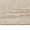 Close up of a cream, wool blend rug featuring a circle geometric design
