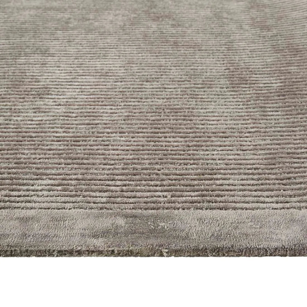 Close up of a grey wool blend floor rug feturing a circular pattern design, by Globe West and Soren Liv nz