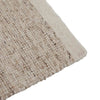 Close up of the corner of a textural woolen rug, in shades of cream, honey brown and light beige, with subtle colour shifts by Soren Liv NZ and Globe West. 