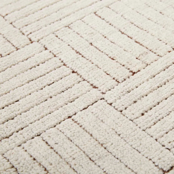 Close up of the Tepih Lattice, a Ivory wool blend floor rug featuring a stylish lattice design