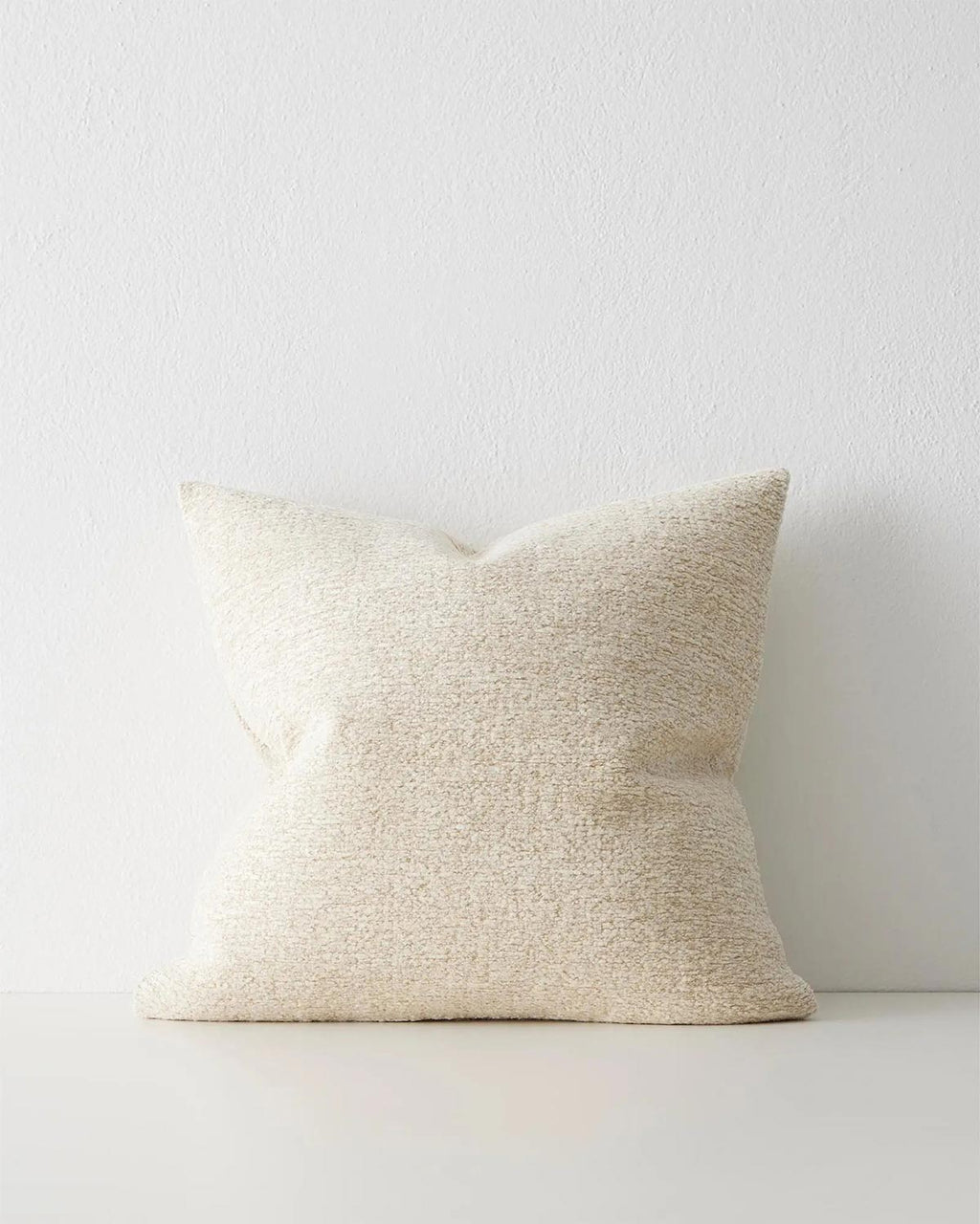A soft textural cream toned cushion. 