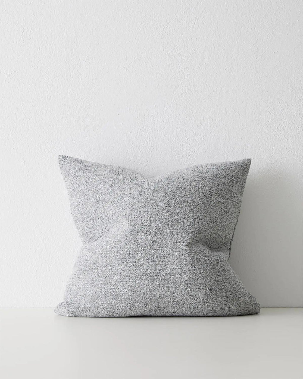 A softly textured blue-grey cushion. 