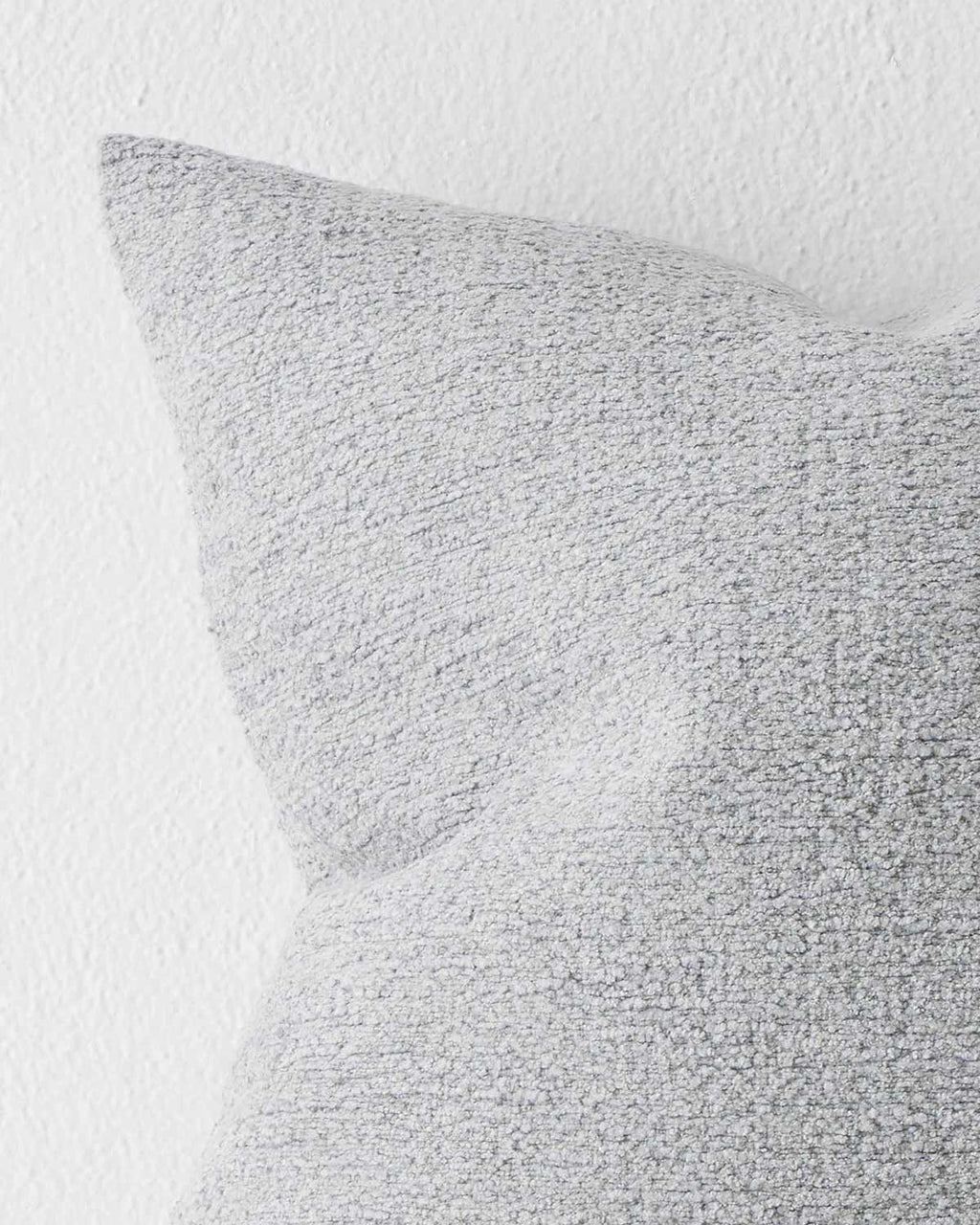 A soft textural muted light blue grey cushion. 