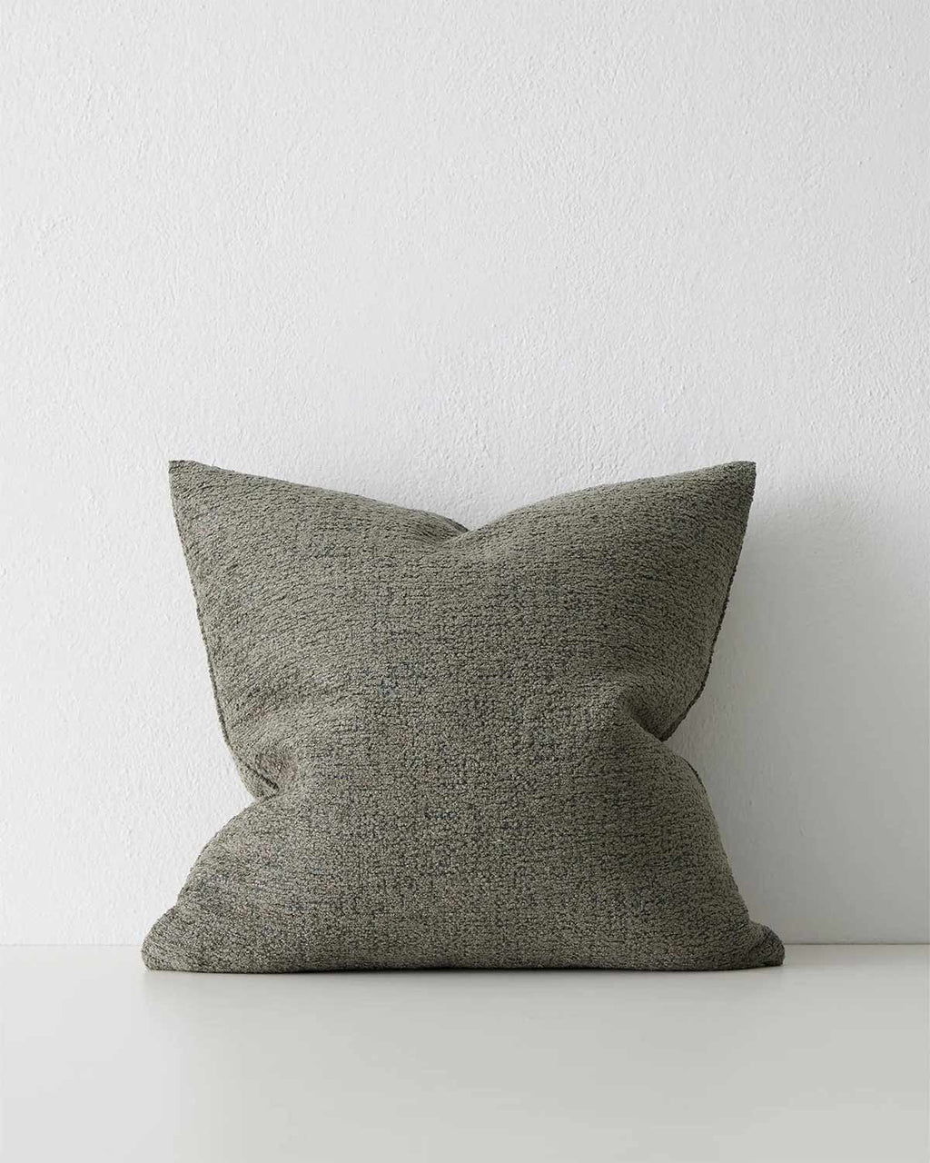 A muted deep green textural cushion. 