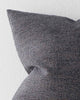 A detailed view of a textural cushion in a deep muted navy blue tone. 