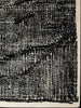 A corner of the black and white Elio 100% wool rug by Tribe Home, shown from abive