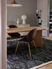 The black and white Elio 100% wool rug by Tribe Home, shown in a contemporary dining room.