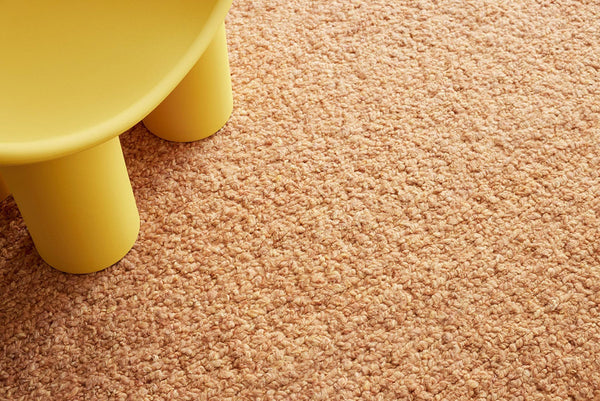 The Tribe Home Roam wool rug in colour 'Sunrise' seen here close up under a chair leg