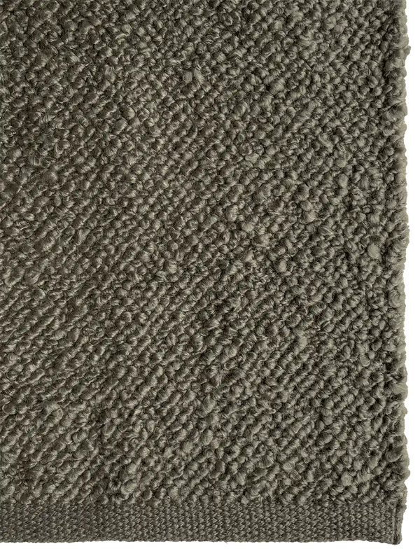 Close up of the Tribe Home Finn outdoor rug in mud green