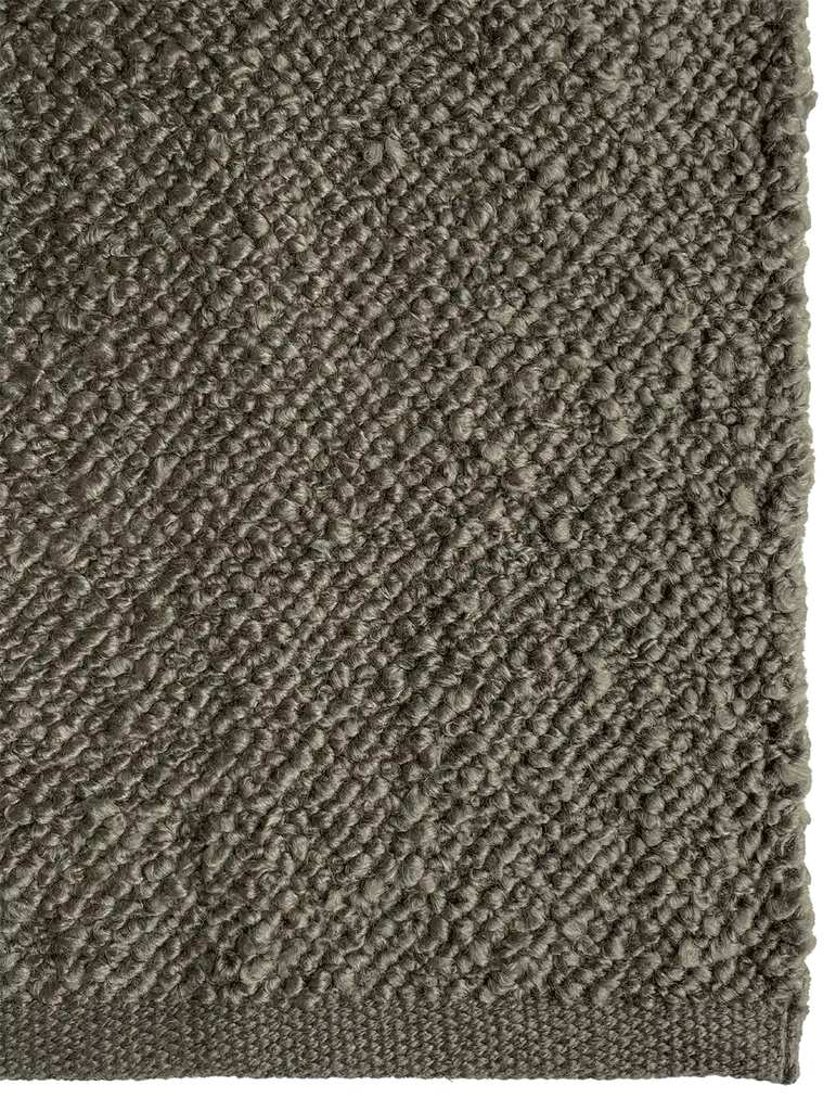 Close up of the Tribe Home Finn outdoor rug in mud green