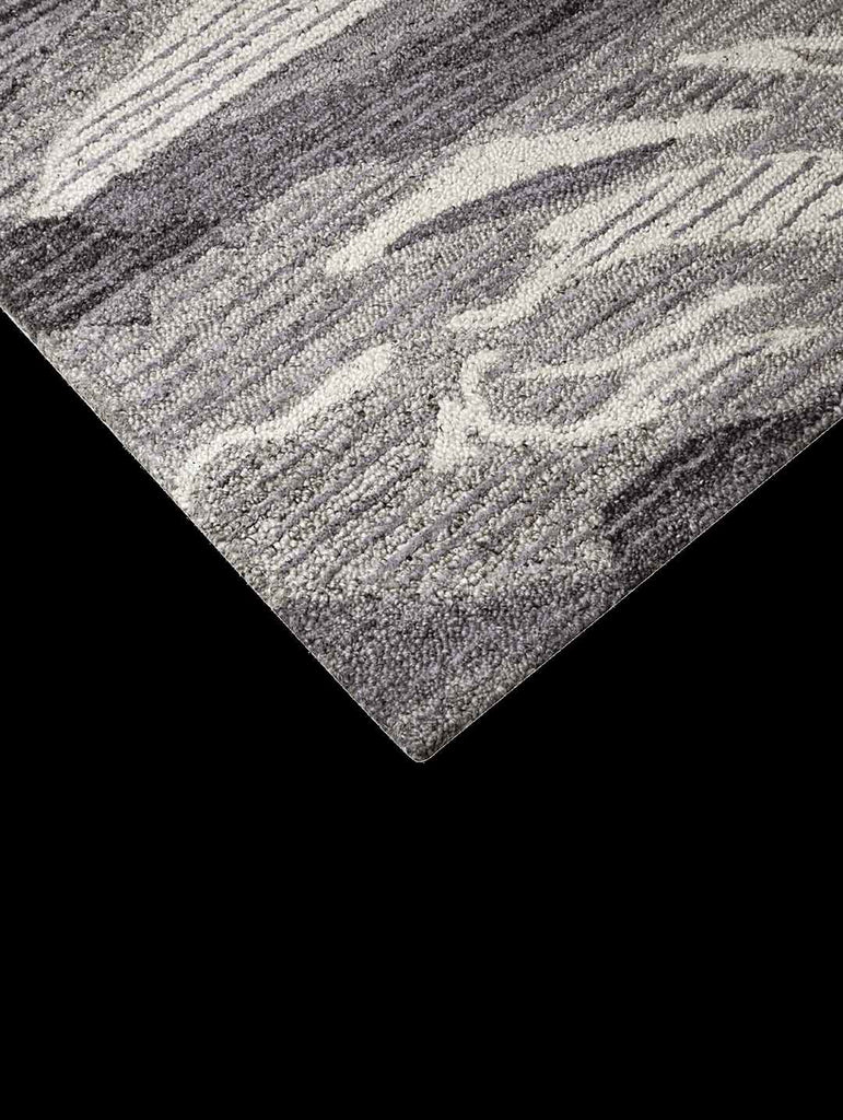 Corner of the The Tribe Home 100% wool Hendrix rug in colours grey, ivory and blue, shown from above