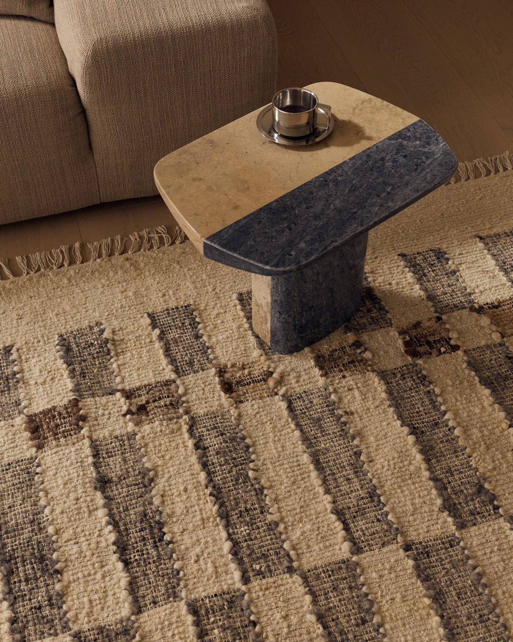 Close view of the Tribe Home Chet wool and jute rug beneath a coffee table