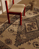 Close view of the Tribe Home Ellora wool and jute rug's diamond motif beside a red chair