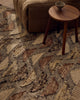 Close view of the Tribe Home Orissa wool and jute rug's half-moon pattern beside a side table