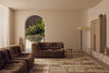 Tribe Home Rama wool and jute rug in Cinnamon in a living room with brown sofas