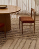 Tribe Home Tulsi wool and jute rug in Caraway under a round dining table and chair