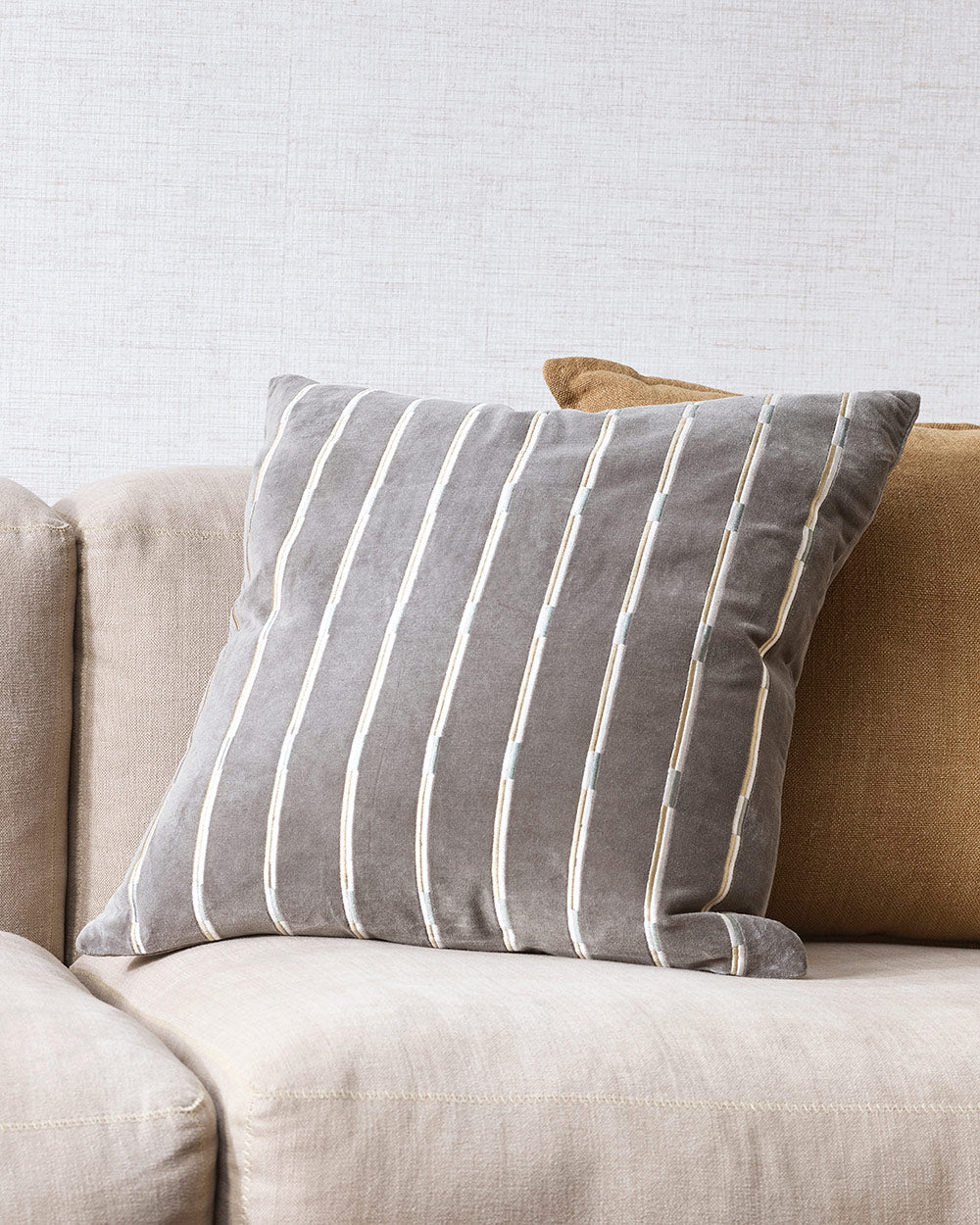 A close up of a velvet cushion, with a textural linear pattern in a gorgeous blue-grey slate shade. 