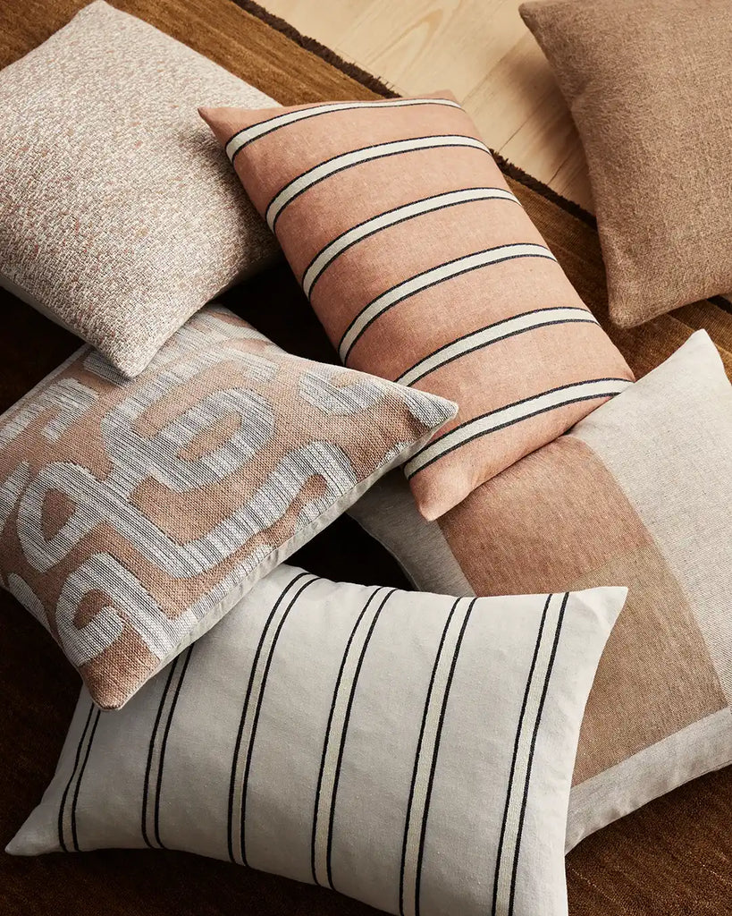 A selection of warm-toned brown and cream cushions from the Weave Home Villa Umbra collection