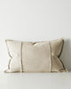 Beige lumbar cushion with textured edges on a light gray background