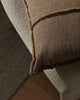 Close-up of a textured brown cushion.