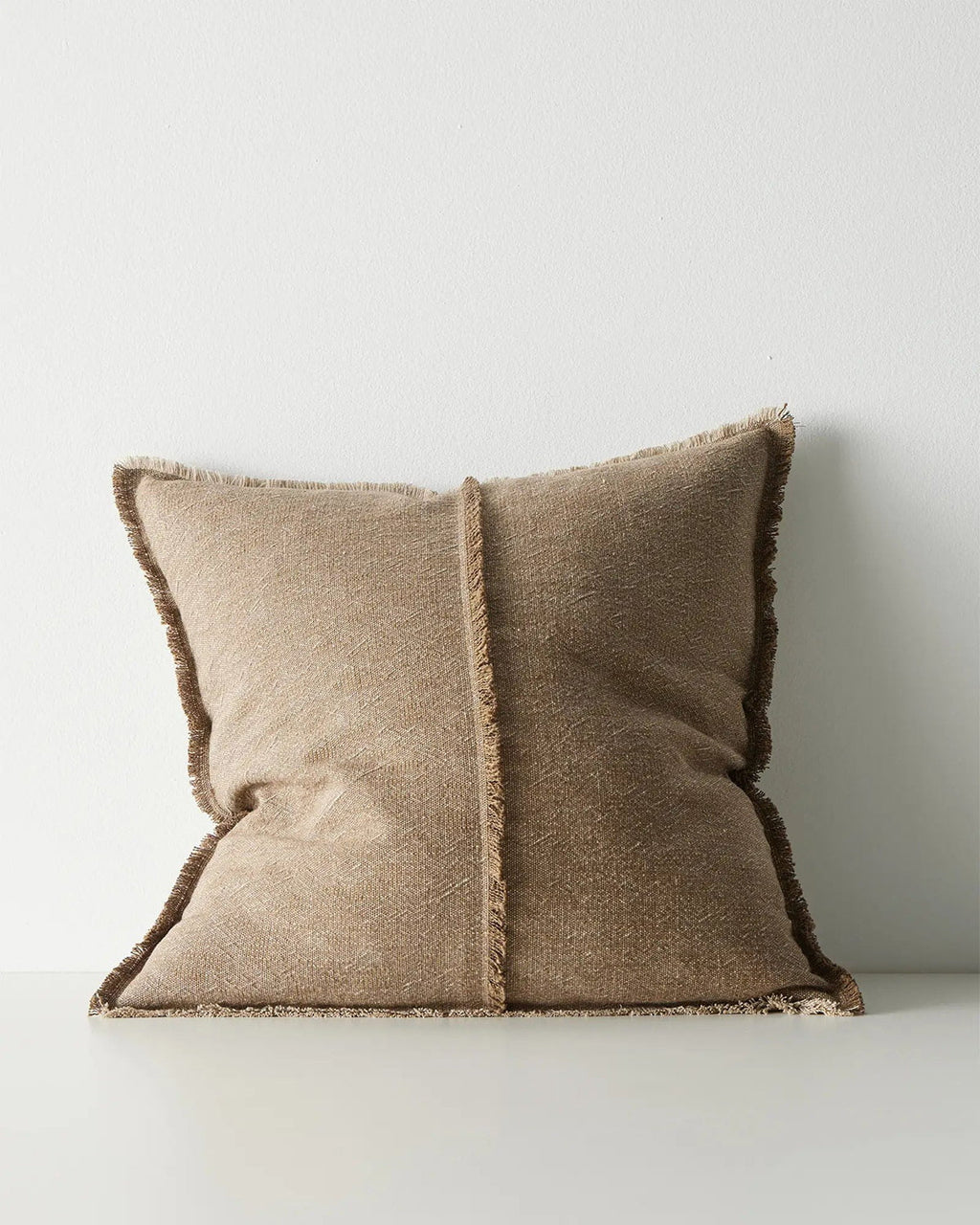 Brown cushion with textured edges on a white background