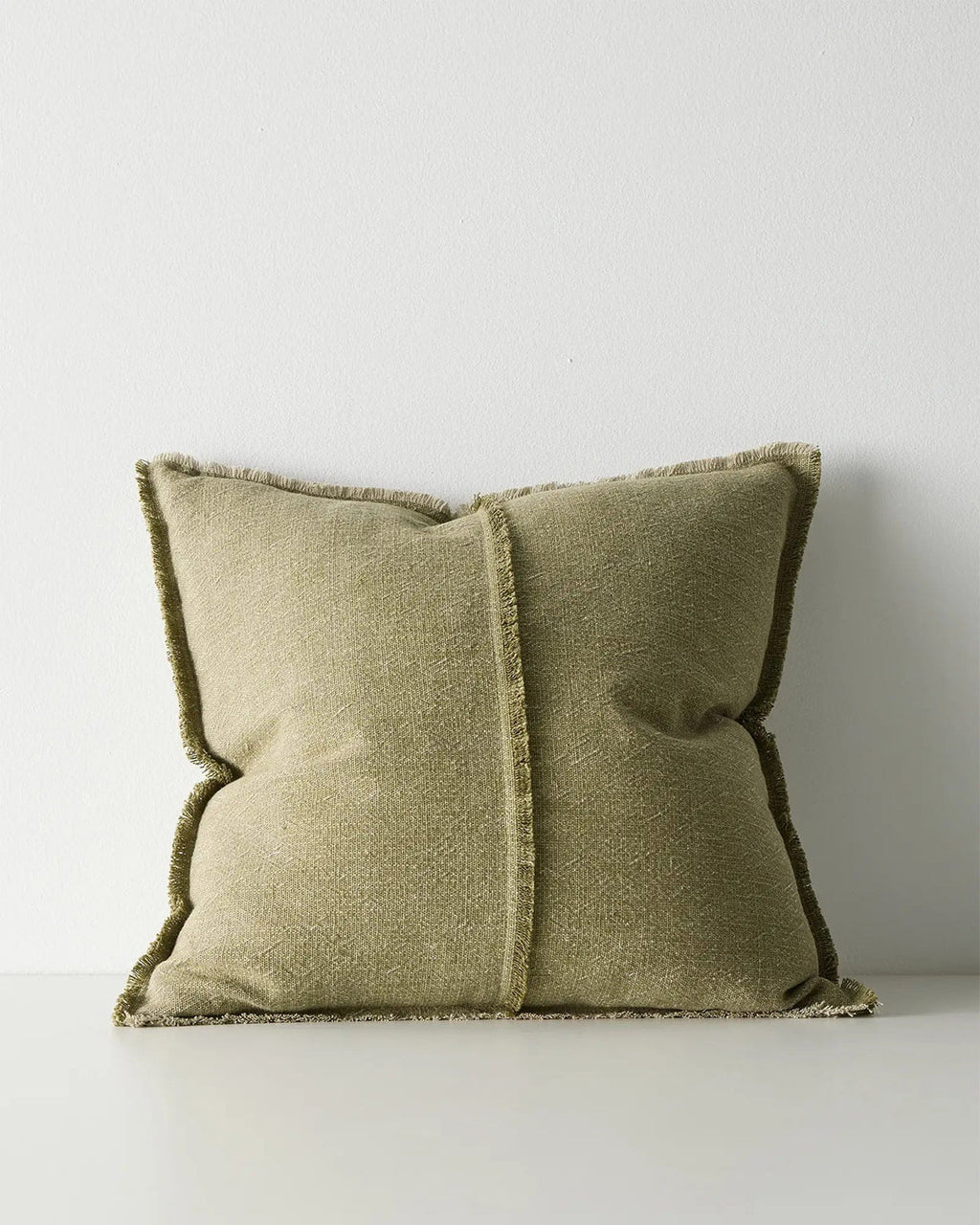 Green cushion with textured edges on a white background