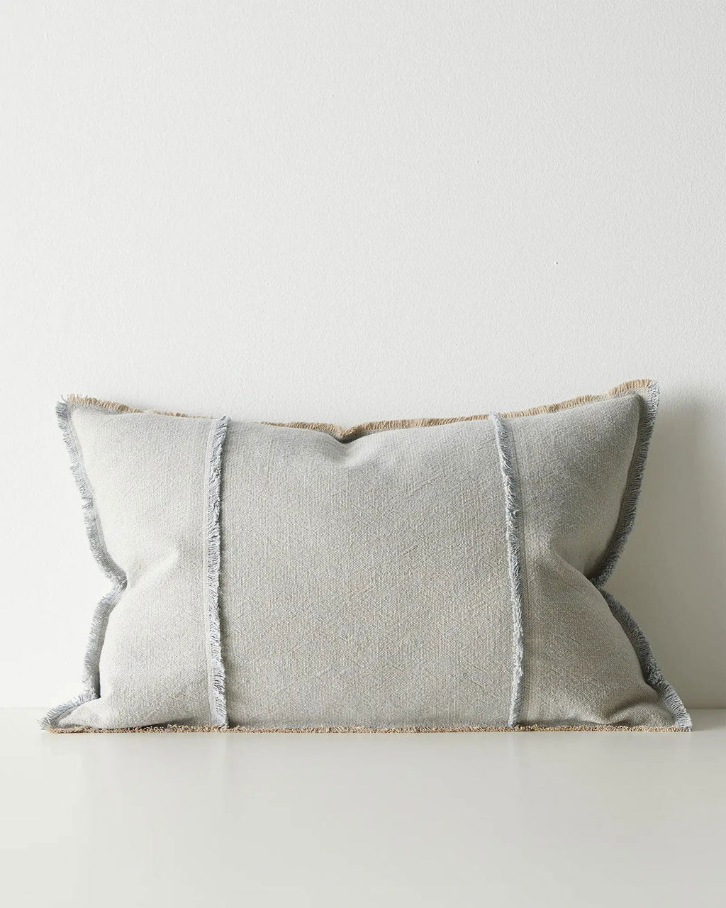 Gray lumbar cushion with textured edges on a white background