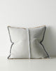 Gray pillow with textured trim on a light gray background