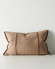Red-brown lumbar cushion with frayed edges on a white background