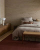 Bedroom with wooden furniture and textured walls