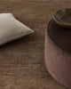 Textured brown rug with a beige Weave Home 'Alba' cushion and bowl on top