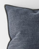 Close up corner of a designer cushion in blue with stitching detail